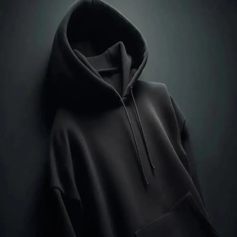 dark black pullover hoodie displayed against a dark background highlighting its clean stitching . ideal for branding and fashion wear. hoodies manufacturer in pakistan