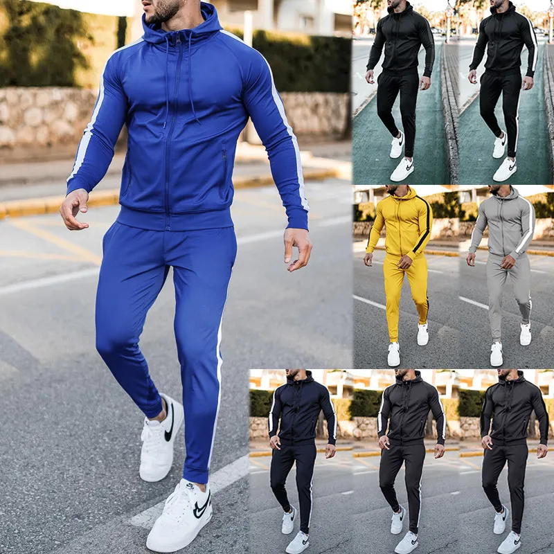 male model wearing a premium athletic blue, black, yellow and grey tracksuit. designed by a high quality tracksuit manufacturer