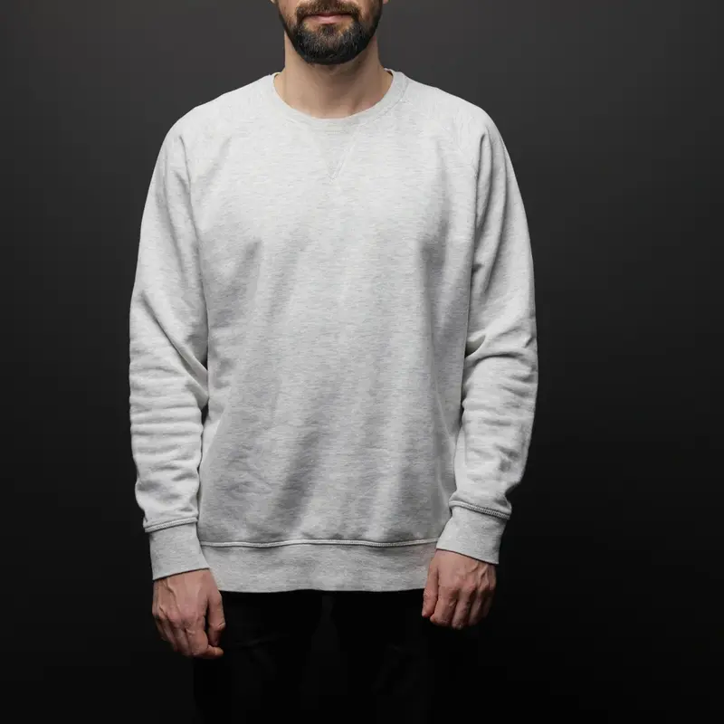 male wearing white color sweatshirt with dark background designed by a sweatshirt wholesale supplier