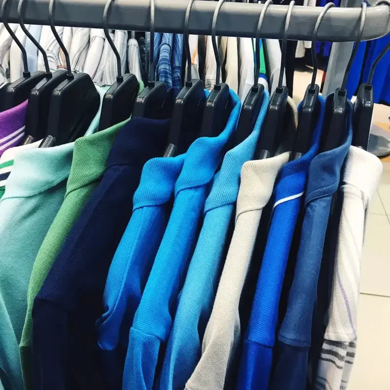 colorful polo shirts hanging in cheez clothing store in sialkot pakistan